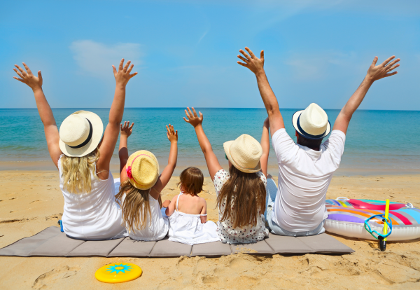 Family relaxing on the beach of Son Bou, near the Hotel Arenas de Son Bou in Menorca, ideal for a vacation in the Balearic Islands.